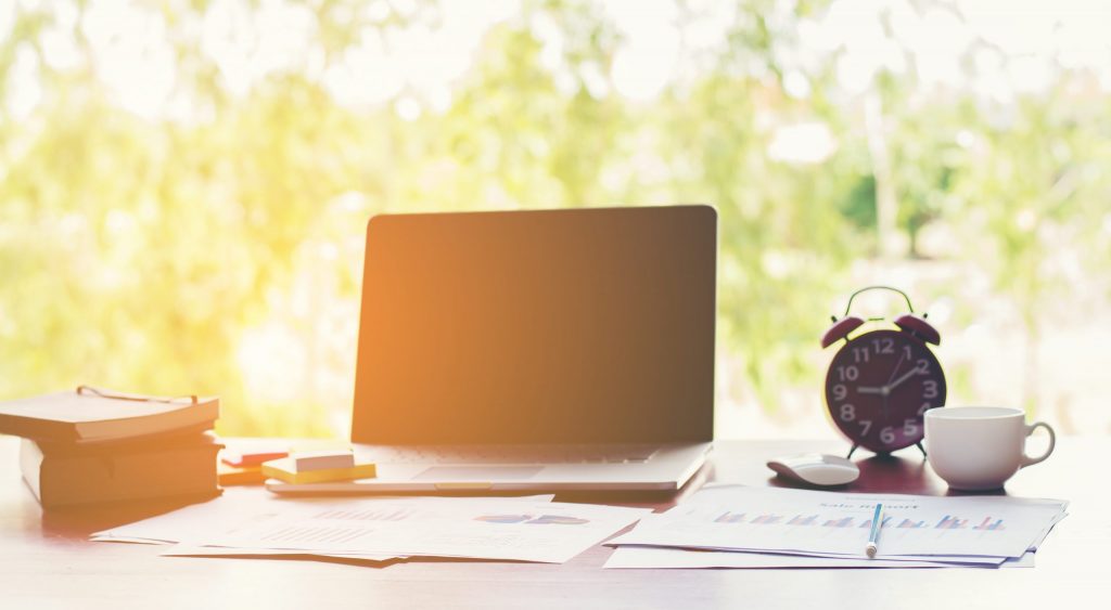 Bright, organized workspace with a laptop, books, coffee, and charts—reflecting Wordiva’s promise of effortless, empowered content creation.