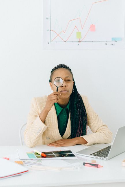 marketing founder analyzing blog performance metrics on a laptop with a notebook beside them calm professional workspace